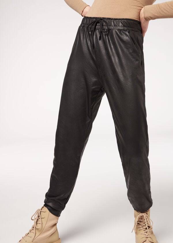pantalones térmicos negros de efecto cuero de calzedonia para mujer